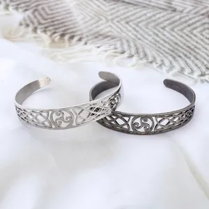 Close-up of Viking Celtic knot and Triskele details on titanium steel cuff bracelets