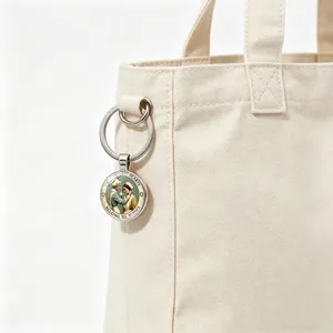 Close-up of nurse keychain charm attached to a canvas tote bag handle