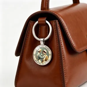 Detailed close-up of a nurse keychain charm with inspirational quote on a brown leather bag