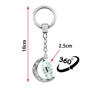 Detail of 360-degree rotating moon pendant keychain with 10cm length and metal chain.
