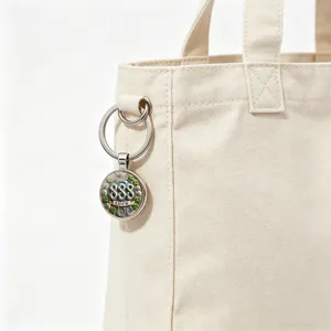 Detail shot of a metal keychain with '888' and lucky clover on a canvas bag
