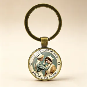 Detail view of a vintage nurse keychain with an antique bronze finish and glass cabochon pendant.