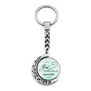 Close-up detail of 360-degree rotating moon keychain with Luke 1:37 scripture quote