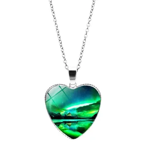 Detailed view of heart-shaped pendant featuring green aurora borealis artwork