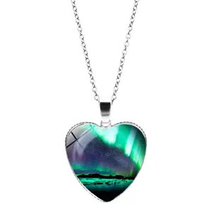 Detail shot of heart-shaped aurora necklace with vibrant starry sky glass pendant