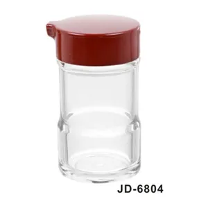 Detailed view of a transparent acrylic condiment bottle with a red lid and spout JD-6804