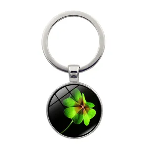 Detailed close-up of a lucky four-leaf clover pendant under a smooth glass cabochon.