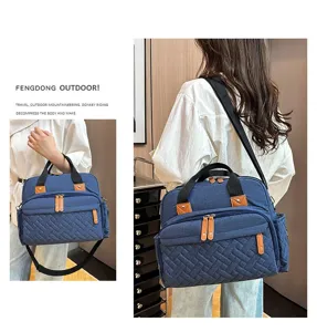 Detail view of blue quilted diaper bag being carried by a model during outdoor travel.