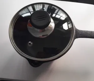 Top view detail showing the transparent glass lid and black knob of 16cm cast iron mini pot