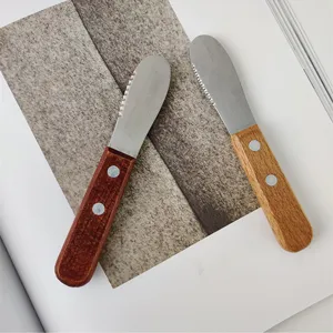 Close-up of retro wooden handle stainless steel butter knives with serrated edges