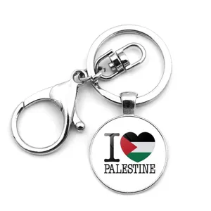 Close-up detail of Palestine flag keychain featuring heart pendant and silver lobster clasp