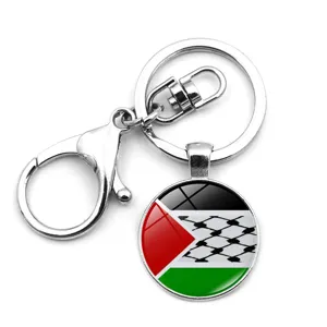 Macro view of Palestine flag keychain pendant featuring traditional Keffiyeh pattern on glass