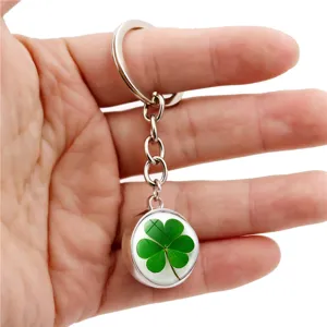 Detailed shot of a four-leaf clover keychain with a crystal glass dome pendant