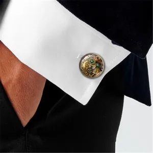 Detailed macro view of steampunk mechanical gear cufflinks on a white shirt cuff.