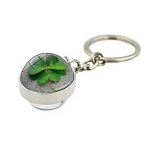 Detail view of a four-leaf clover keychain with a crystal dome for St. Patrick's Day.