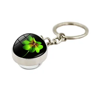 Detailed macro view of silver four-leaf clover glass dome keychain pendant gift