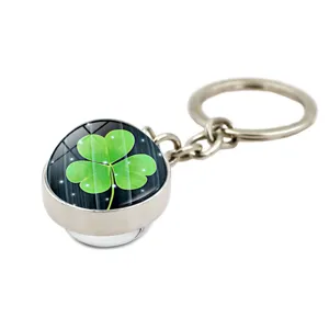 Detail of a metal keychain with a green shamrock crystal ball for St. Patrick's Day.