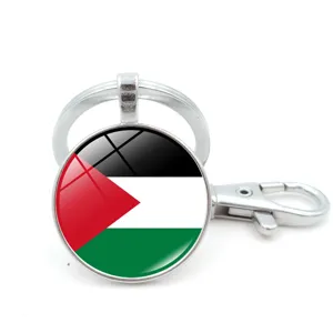 Metal keychain with Palestine flag design under a circular glass cabochon charm.