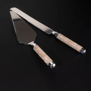 Luxury stainless steel cake server set with glittering gold rhinestone handles for parties.