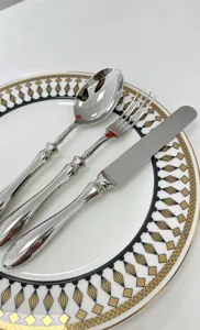 Macro view of high-quality stainless steel cutlery set with elegant gourd handles on plate