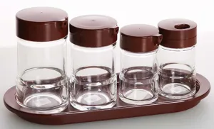 Detailed view of clear acrylic seasoning bottles with brown lids and matching tray