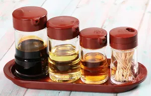 Acrylic seasoning bottle set with red lids and matching tray for oil and vinegar