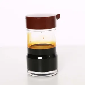 Detailed view of clear acrylic seasoning bottle with brown lid for soy sauce.