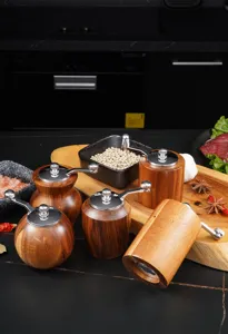 Acacia wood manual pepper grinder with metal crank handle for kitchen spice and salt grinding.