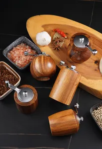Handmade acacia wood spice and pepper grinder set with metal handle, durable kitchen tool.