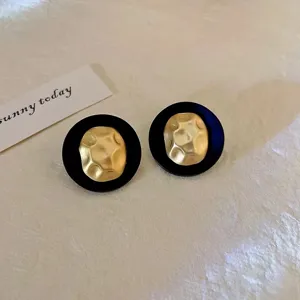 Elegant vintage black flocked round stud earrings featuring a hammered gold center