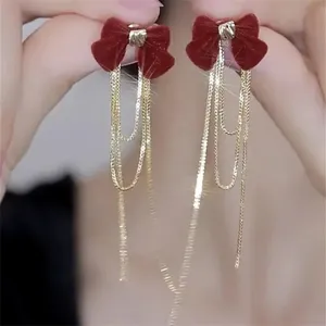 Elegant red velvet bow stud earrings with long gold tassel chains in French style