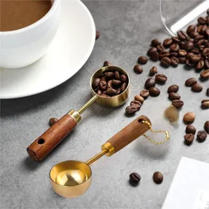 Close-up of gold-plated stainless steel measuring spoons with ergonomic wooden handles