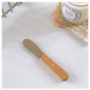Close-up of retro Japanese style butter knife with wooden handle and stainless steel blade