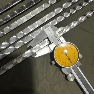 Detailed macro view showing a patterned stainless steel BBQ skewer width measurement