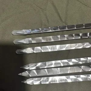 Close-up of flat stainless steel BBQ skewers with decorative circular patterns