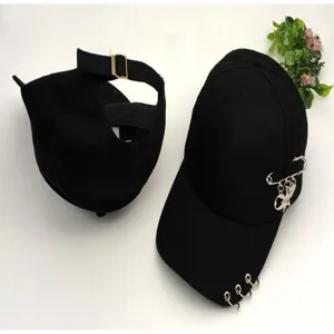 Black cotton baseball cap with metal safety pins, rings, and star pendant for casual streetwear.