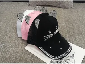 Detail of shiny rhinestone cat ear mesh baseball caps in black, pink and white.
