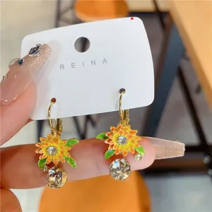 Close-up of sunflower earrings with sparkling crystals in a pastoral style