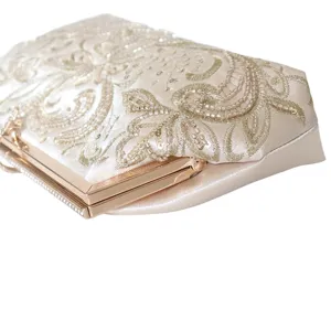 Elegant floral embroidered evening clutch bag with beaded sequins and metallic kiss-lock frame.