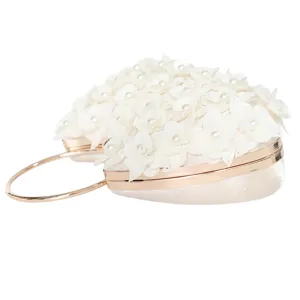 Heart-shaped evening clutch bag with white floral pearls and gold metal handle for party.