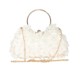 Elegant floral evening clutch bag with pearl accents, gold ring handle and chain strap.