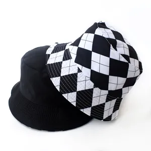 Detailed shot of reversible bucket hat featuring solid black and black-white checkered sides