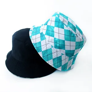 Close-up of black and checkered teal reversible bucket hats for street style