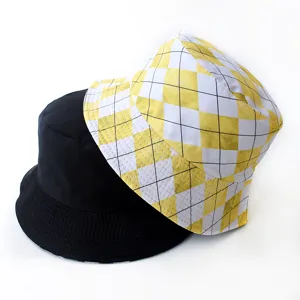 Two stylish bucket hats, one solid black and one yellow plaid, stacked on white