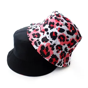 Detail shot of the reversible bucket hat showing black and pink leopard print sides.