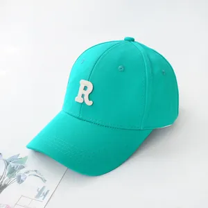 Turquoise baseball cap with white embroidered R letter detail for summer sun protection