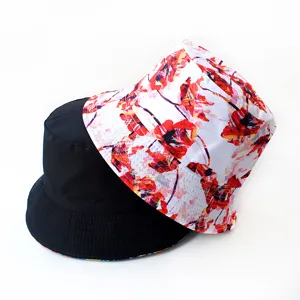 Detailed view of reversible bucket hat showing white abstract floral print and solid black sides.
