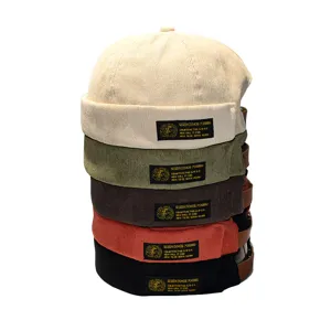 Stack of vintage corduroy brimless docker hats in five different colors