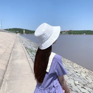 Back view of a minimalist white cotton bucket hat for summer sun protection outdoors