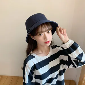 Detailed view of a navy blue Japanese style bucket hat worn by an Asian model
